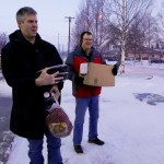 Bracing in the blustery wind, Curtis Townsend and Bob Bechtold haul goods to the pick up to be delivered.